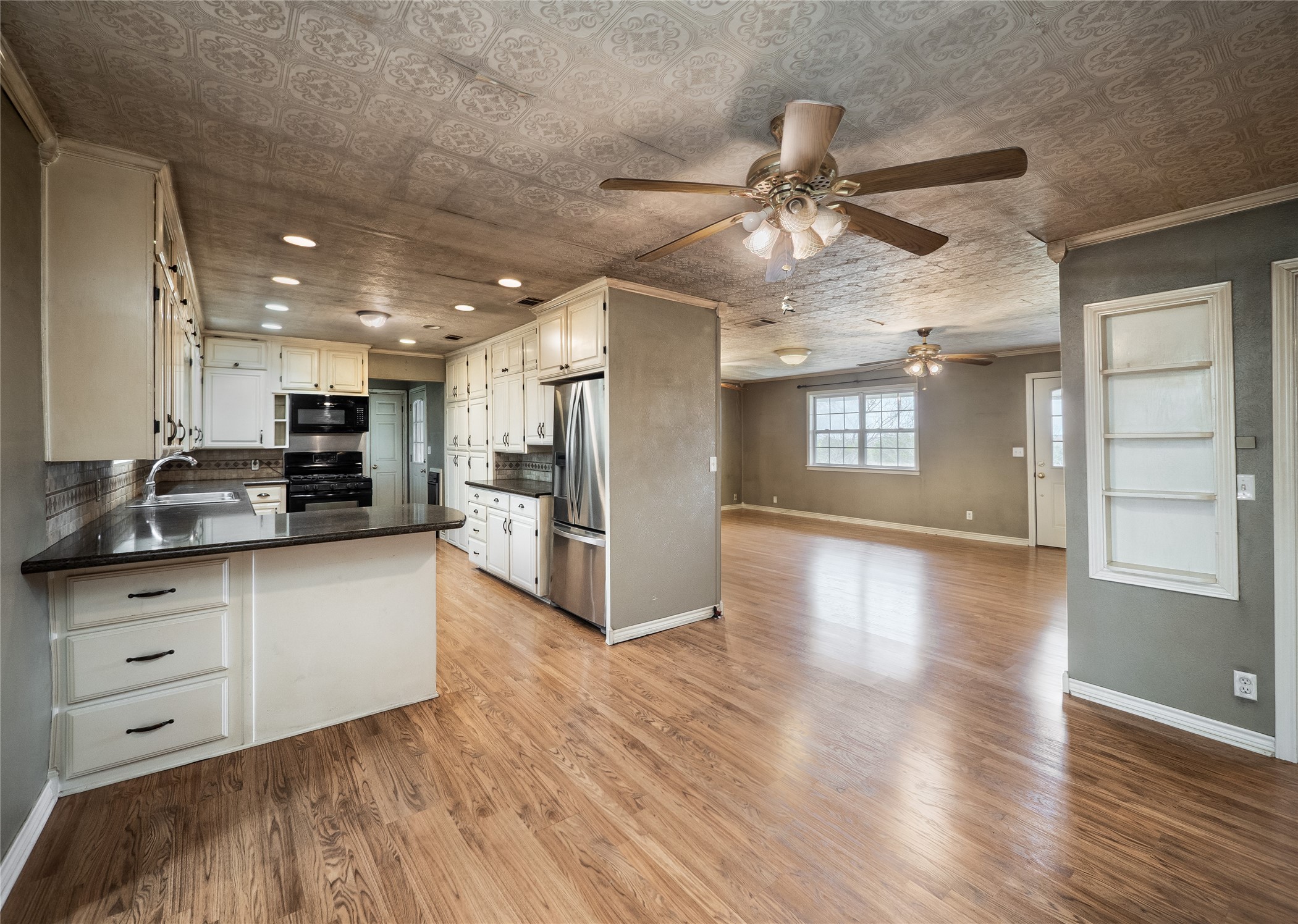 1350 County Road 414 Hamilton, TX 76531 - Photo 6 of 40 a kitchen with stainless steel appliances granite countertop a refrigerator and a stove top oven