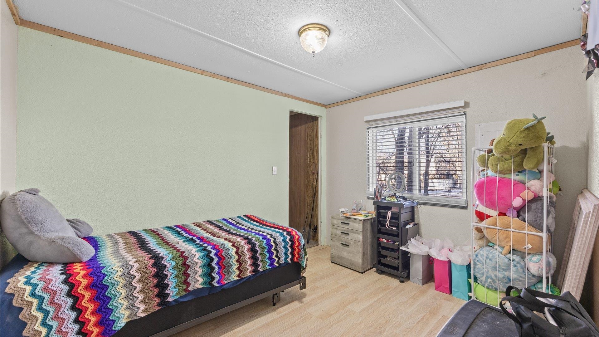 180 1/2 Southwest 8th Avenue Cedaredge, CO 81413 - Photo 11 of 18 a bedroom with a bed and wooden floor
