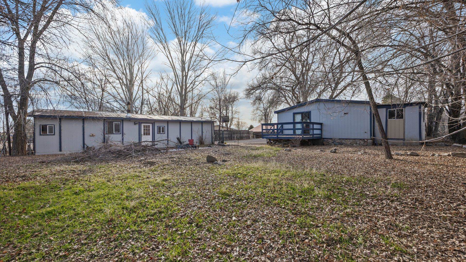 180 1/2 Southwest 8th Avenue Cedaredge, CO 81413 - Photo 16 of 18 a view of a yard with a house and a tree