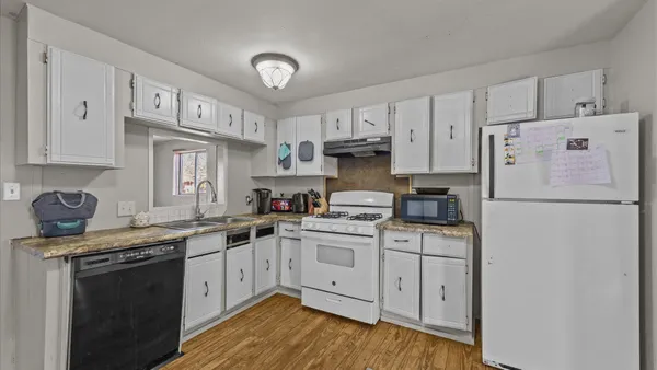 a kitchen with a white cabinets and white appliances