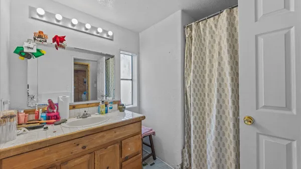 a bathroom with a sink vanity and a mirror