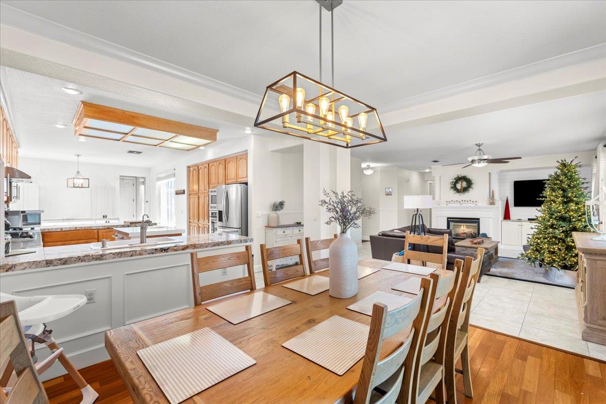 9168 Sipler Way Elk Grove, CA 95758 - Photo 11 of 35 a view of a dining room and livingroom with furniture wooden floor a chandelier