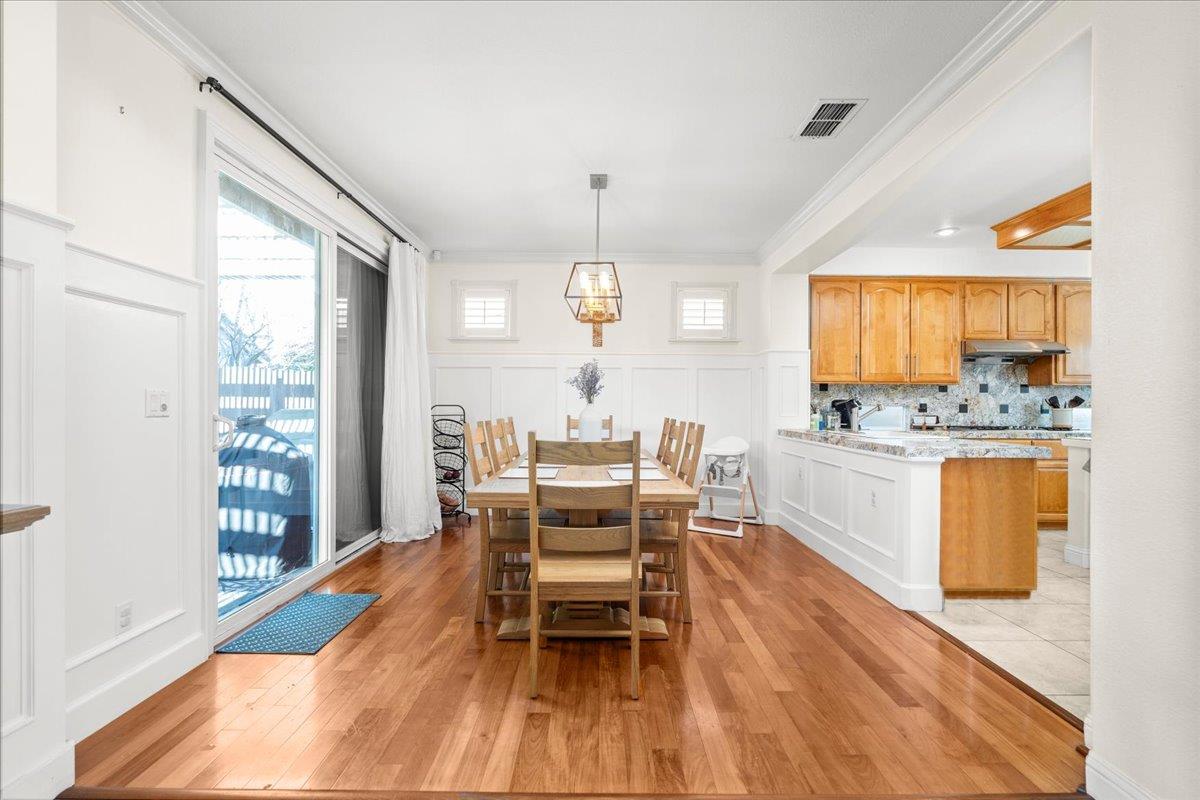 9168 Sipler Way Elk Grove, CA 95758 - Photo 12 of 35 a view of a dining room with furniture window and wooden floor