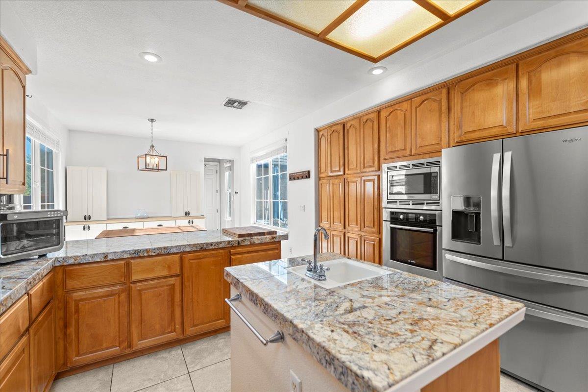 9168 Sipler Way Elk Grove, CA 95758 - Photo 13 of 35 a kitchen with stainless steel appliances granite countertop a sink stove and refrigerator