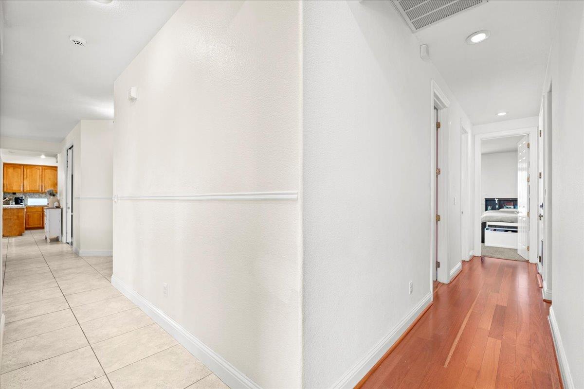 9168 Sipler Way Elk Grove, CA 95758 - Photo 17 of 35 a view of a hallway with wooden floor and a living room
