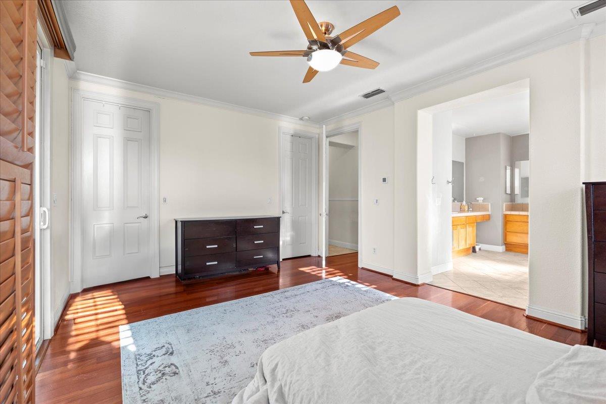 9168 Sipler Way Elk Grove, CA 95758 - Photo 19 of 35 a bedroom with a bed and a chandelier