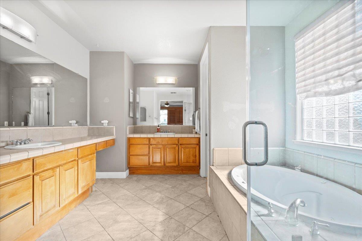 9168 Sipler Way Elk Grove, CA 95758 - Photo 20 of 35 a large spacious bathroom with a granite countertop tub sink and mirror