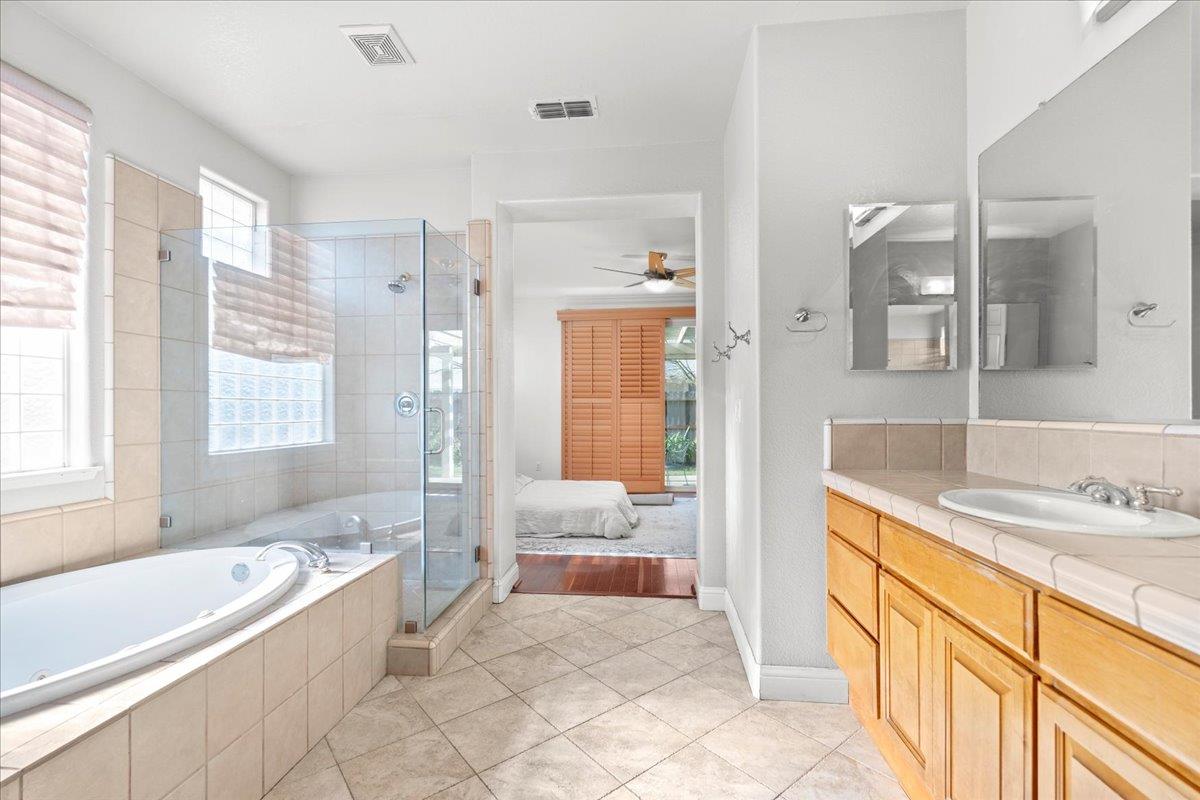 9168 Sipler Way Elk Grove, CA 95758 - Photo 21 of 35 a spacious bathroom with a tub sink and mirror