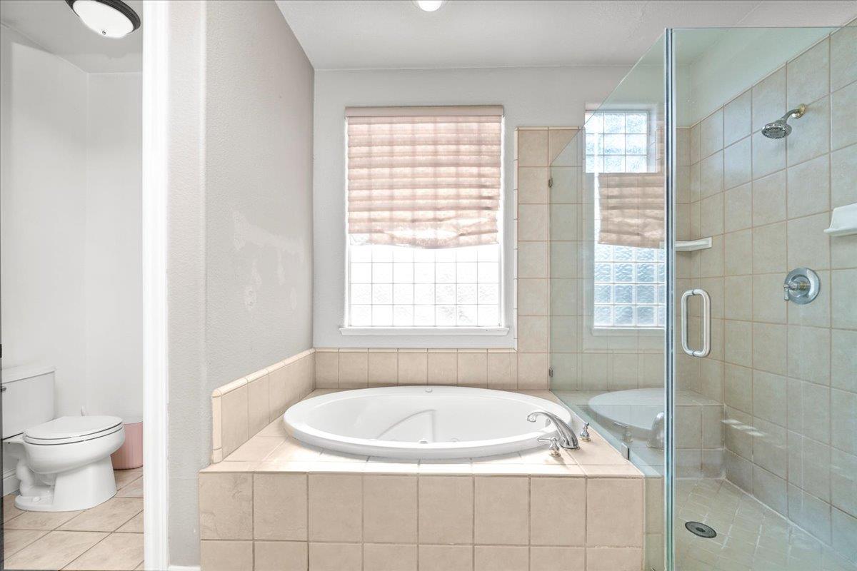 9168 Sipler Way Elk Grove, CA 95758 - Photo 22 of 35 a white bath tub sitting next to a white toilet