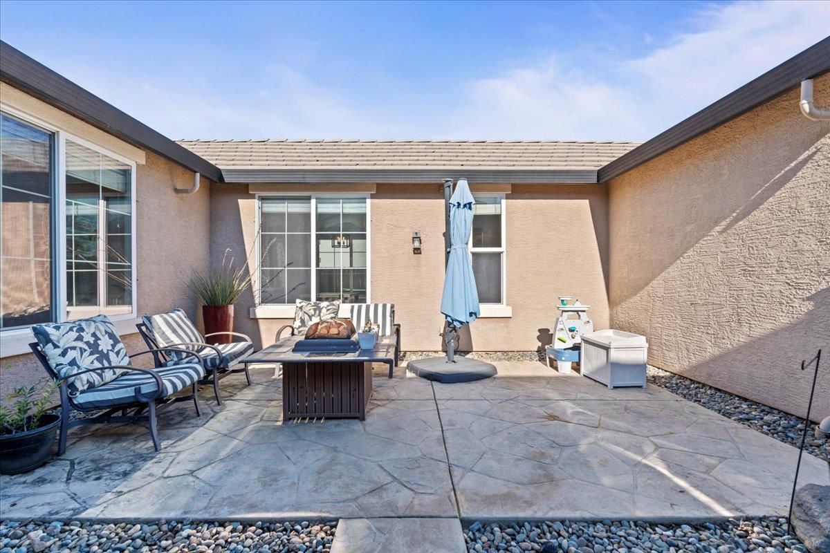 9168 Sipler Way Elk Grove, CA 95758 - Photo 4 of 35 a outdoor space with patio furniture and white couches
