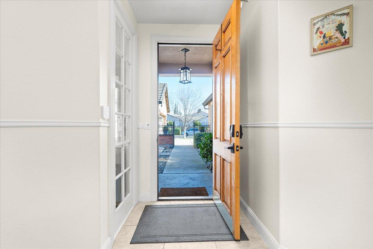 9168 Sipler Way Elk Grove, CA 95758 - Photo 5 of 35 a view of a hallway with wooden floor and windows