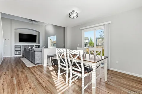 a view of a dining room with furniture window and wooden floor
