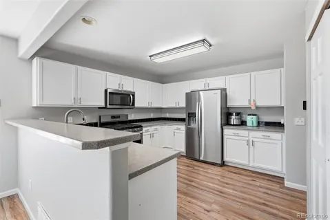 a kitchen with stainless steel appliances a refrigerator stove microwave and sink
