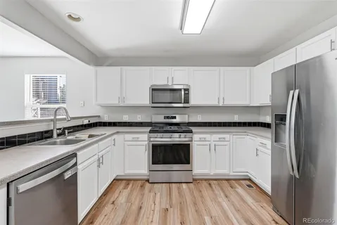 a kitchen with a sink stove and refrigerator