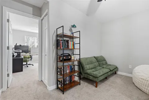 a living room with furniture and a book shelf