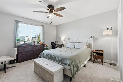 a bedroom with a bed a desk and chair