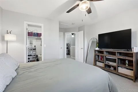a bedroom with bed and flat screen tv