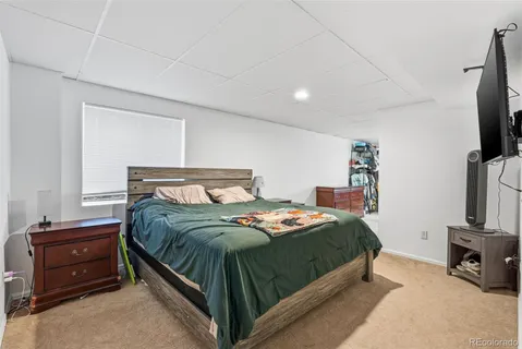 a bedroom with a bed and a tv on table