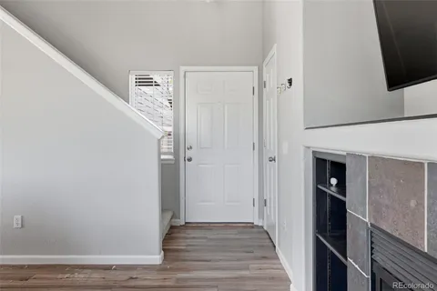 a view of a hallway with wooden floor and staircase