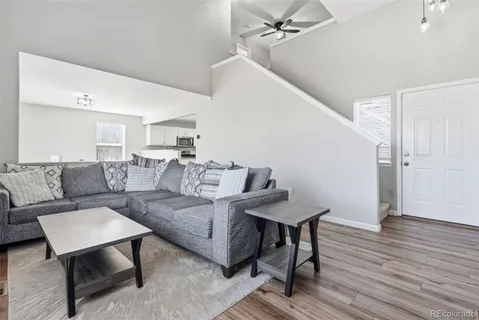 a living room with furniture and wooden floor