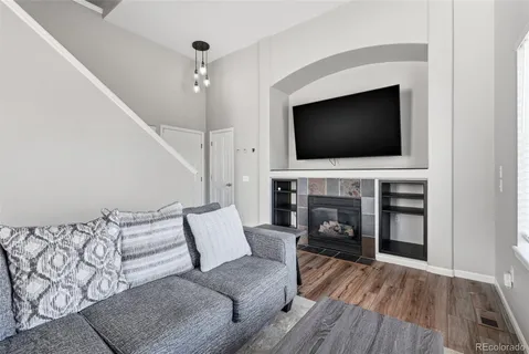 a living room with furniture fireplace and flat screen tv