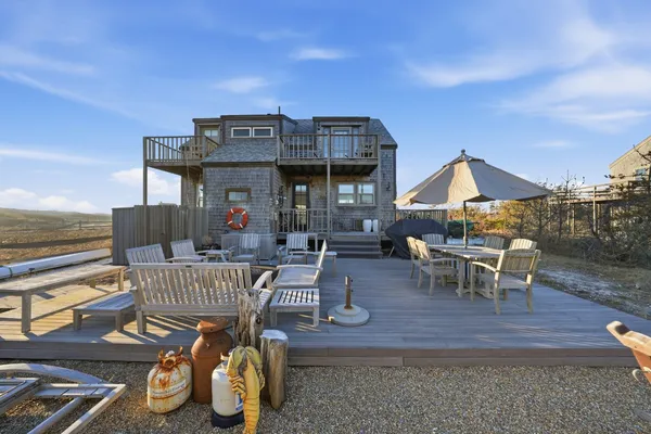 a view of a deck with two couches and wooden floor