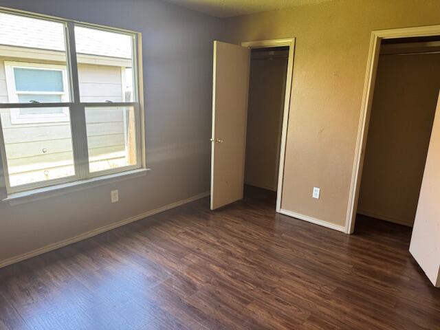 817 Ute Avenue Lubbock, TX 79403 - Photo 12 of 17 an empty room with wooden floor and windows