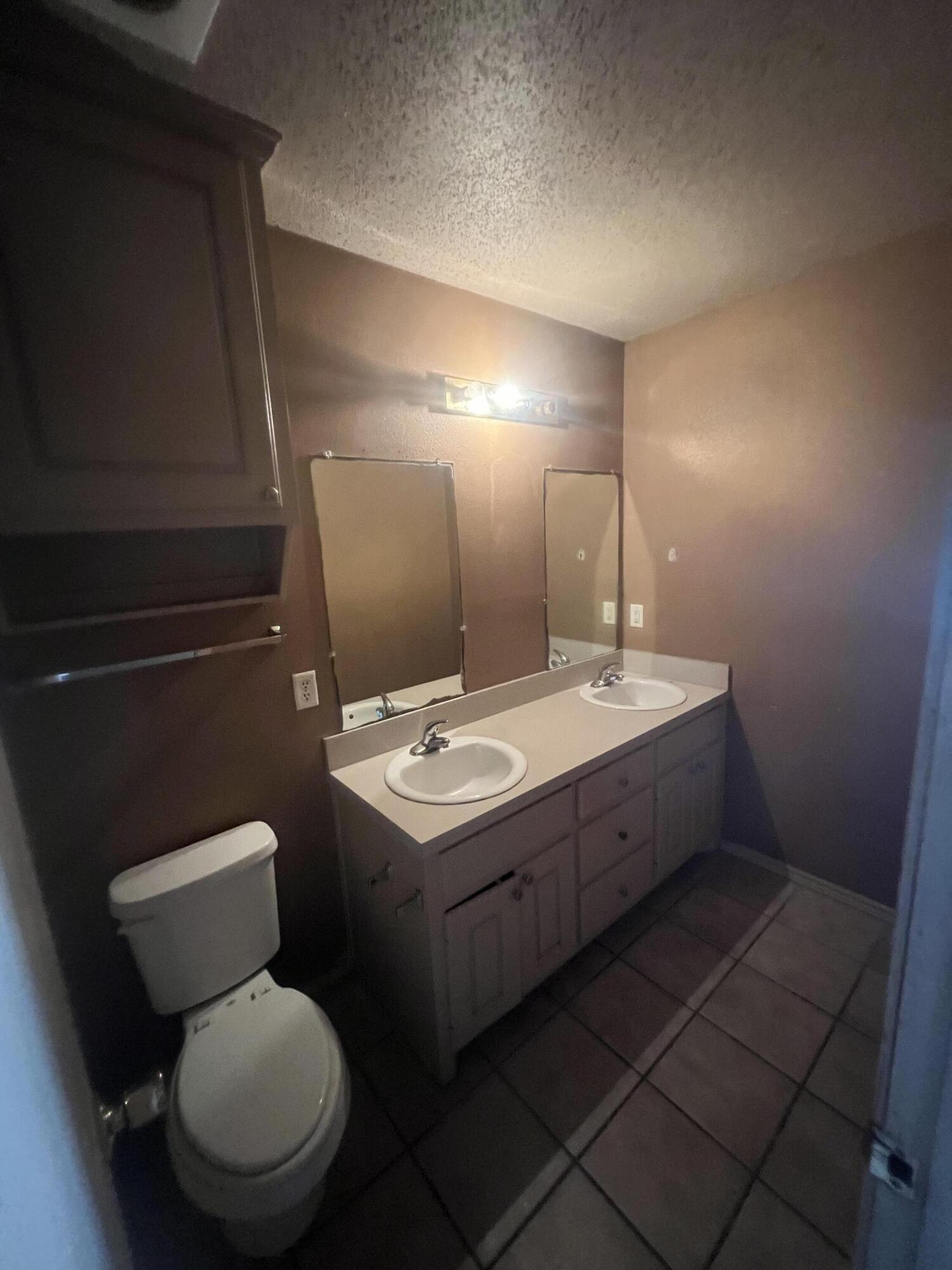 817 Ute Avenue Lubbock, TX 79403 - Photo 13 of 17 a bathroom with a toilet sink and mirror