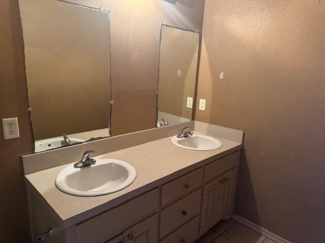 817 Ute Avenue Lubbock, TX 79403 - Photo 14 of 17 a bathroom with a sink and a mirror