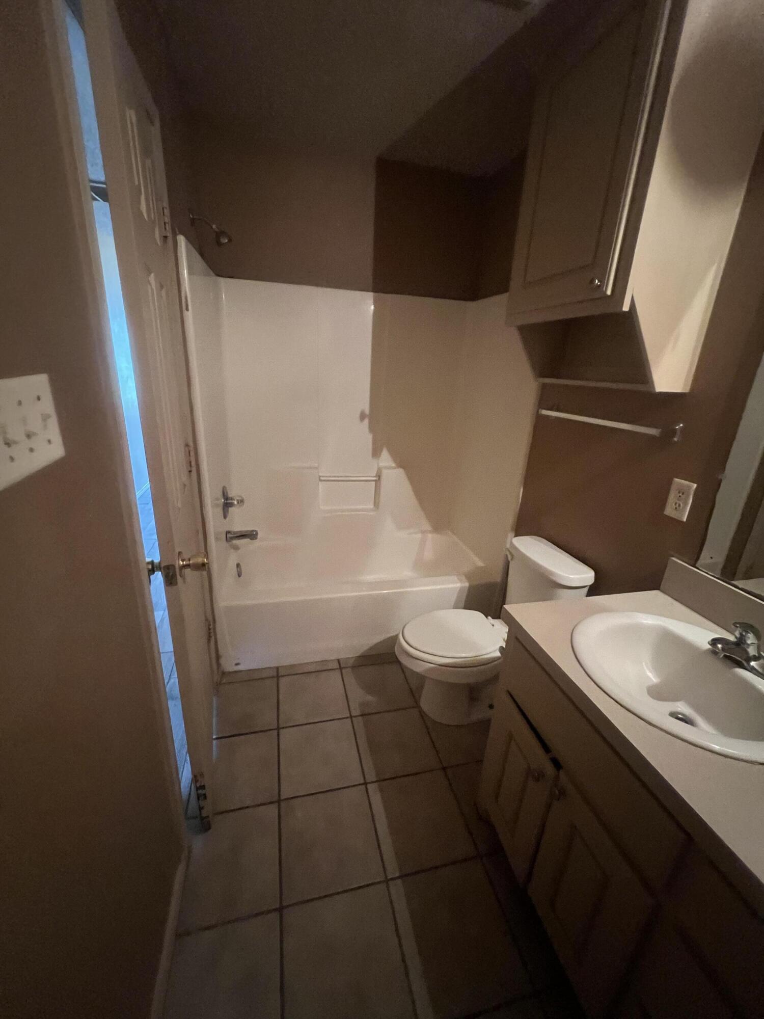 817 Ute Avenue Lubbock, TX 79403 - Photo 15 of 17 a bathroom with a sink a toilet and tub