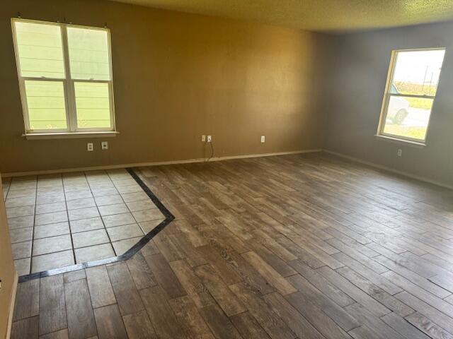 817 Ute Avenue Lubbock, TX 79403 - Photo 4 of 17 an empty room with wooden floor and windows