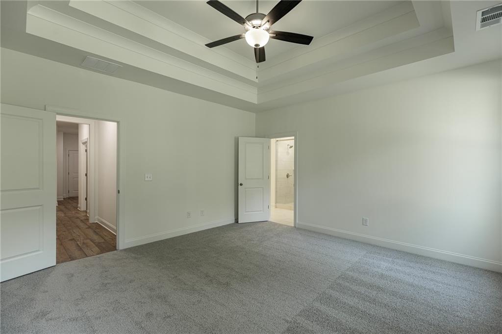 1210 Austin Road Winder, GA 30680 - Photo 34 of 56 an empty room with closet and a chandelier fan