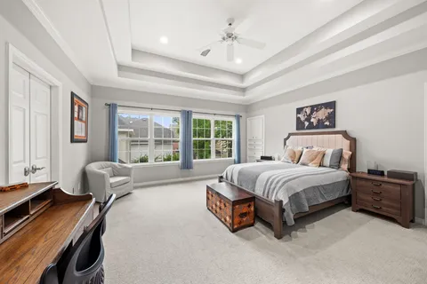 a spacious bedroom with a bed and a desk