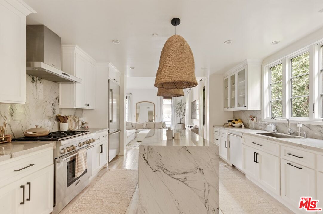 1436 Ethel Street Glendale, CA 91207 - Photo 12 of 47 a large kitchen with stainless steel appliances kitchen island granite countertop a sink and cabinets