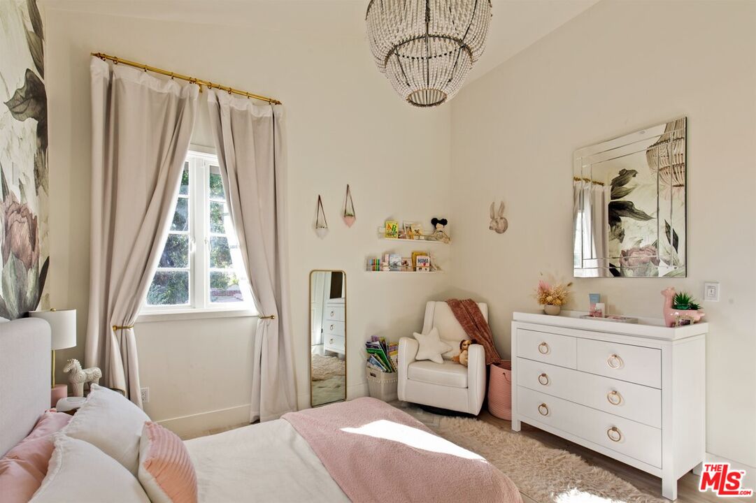 1436 Ethel Street Glendale, CA 91207 - Photo 33 of 47 a bedroom with a bed and a chandelier