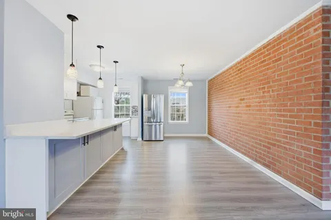 a large kitchen with cabinets and wooden floor