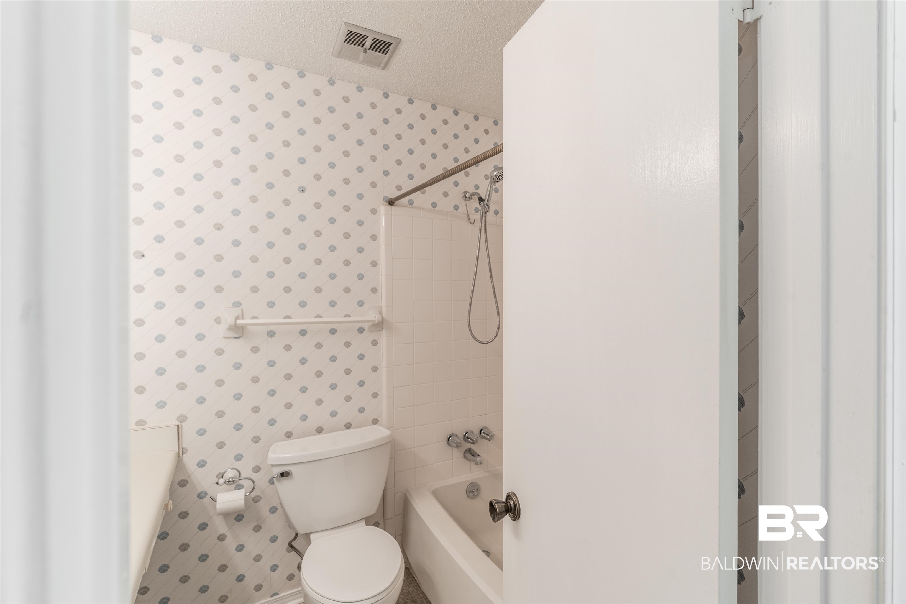9751 Pine Knoll Road Mobile, AL 36608 - Photo 17 of 36 Bathroom with wallpapered walls, shower / washtub combination, and a textured ceiling
