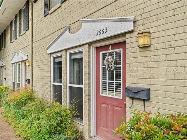 a front view of a building with potted plants