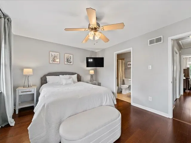 a bathroom with a granite countertop sink toilet a mirror and shower