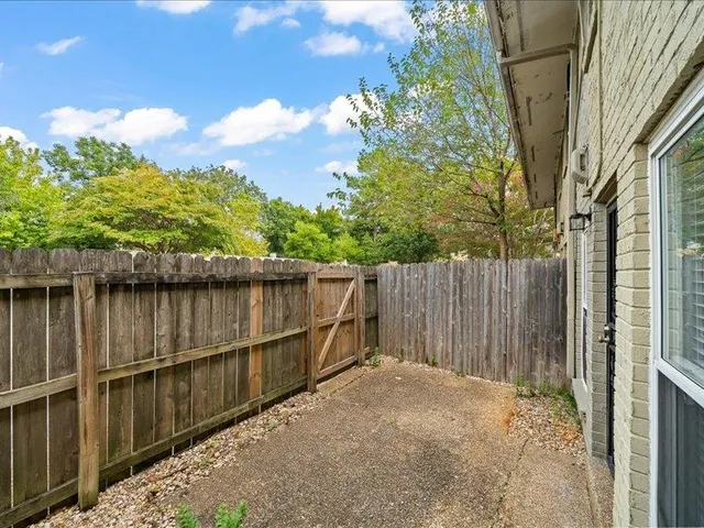 a spacious bedroom with a bed and a chandelier