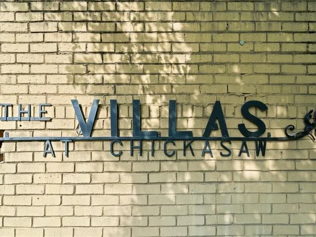 a bathroom with a granite countertop toilet a sink and a mirror
