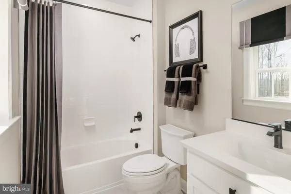 a bathroom with a toilet a sink and a mirror