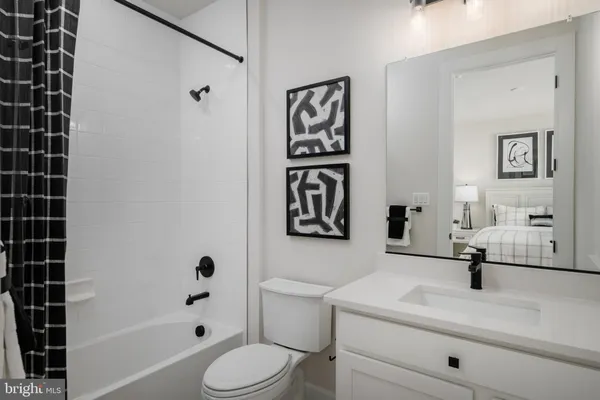 a bathroom with a toilet sink and shower