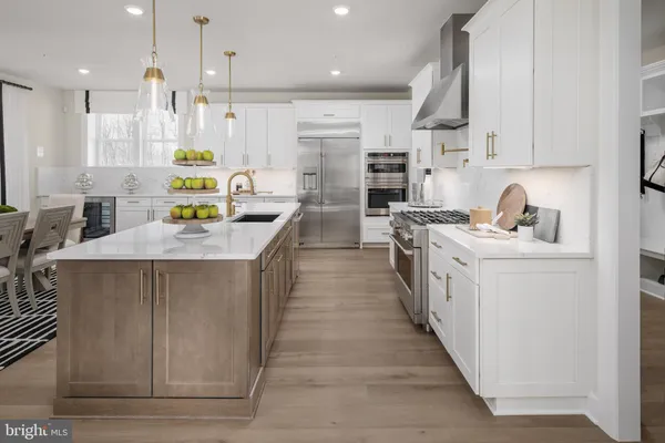 a kitchen with kitchen island stainless steel appliances a sink stove and refrigerator