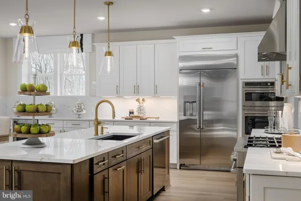 a kitchen with stainless steel appliances a sink stove and refrigerator