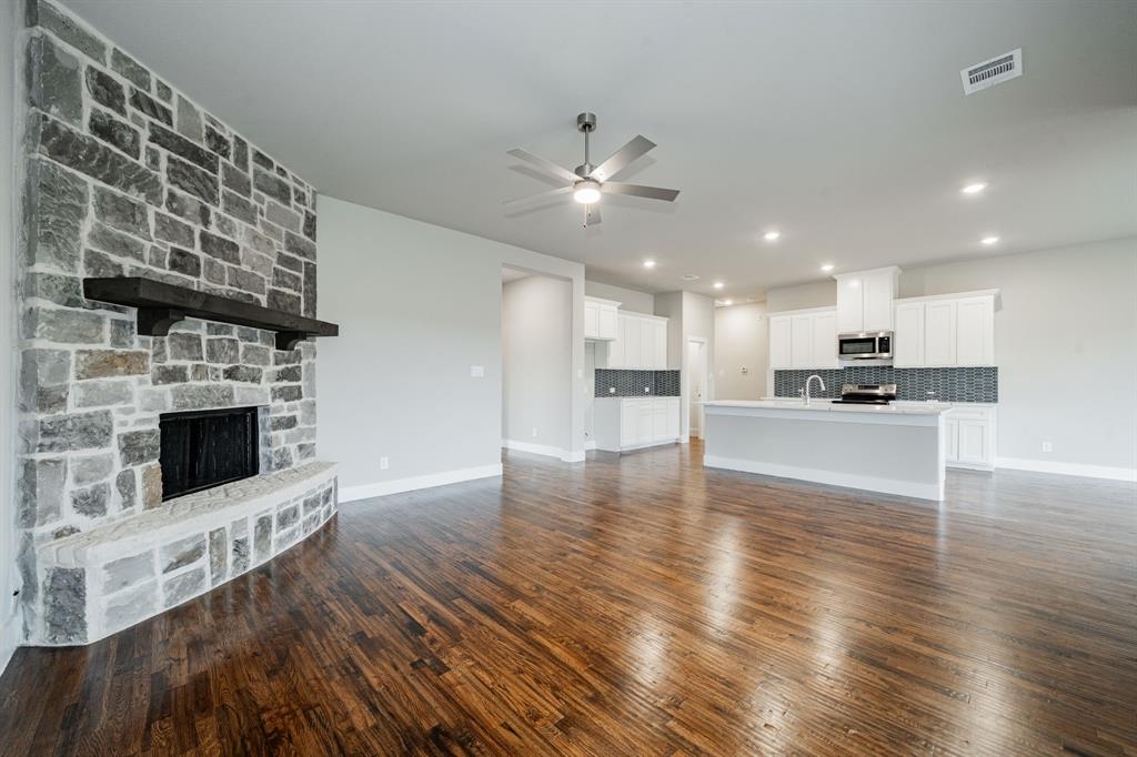 424 Deer Lane Celeste, TX 75423 - Photo 12 of 40 a view of an empty room with kitchen and fireplace