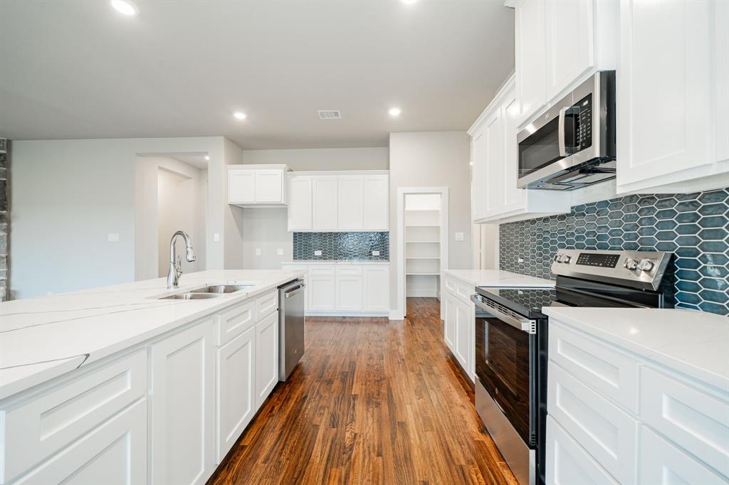 424 Deer Lane Celeste, TX 75423 - Photo 17 of 40 a kitchen with a sink stove microwave and cabinets
