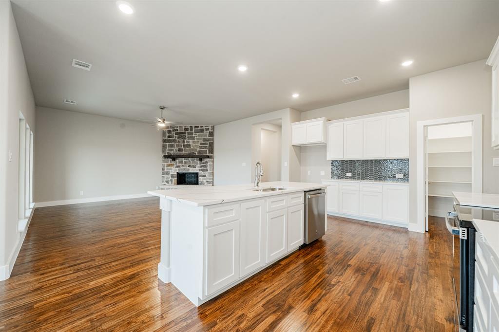 424 Deer Lane Celeste, TX 75423 - Photo 18 of 40 a large kitchen with stainless steel appliances a large counter top a stove and a wooden floors