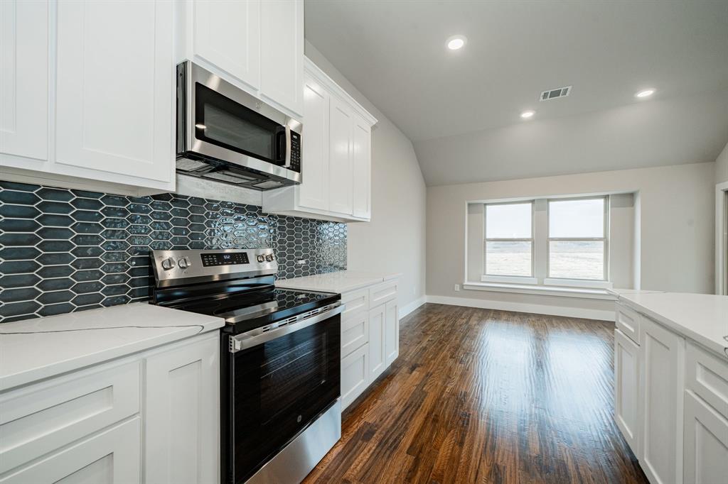 424 Deer Lane Celeste, TX 75423 - Photo 20 of 40 a kitchen with stainless steel appliances a stove sink microwave and cabinets
