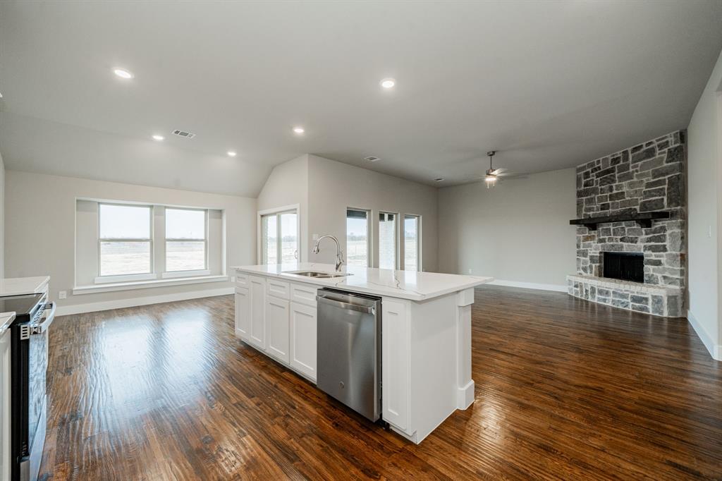 424 Deer Lane Celeste, TX 75423 - Photo 22 of 40 a kitchen with stainless steel appliances a kitchen island hardwood floor sink stove and wooden cabinets